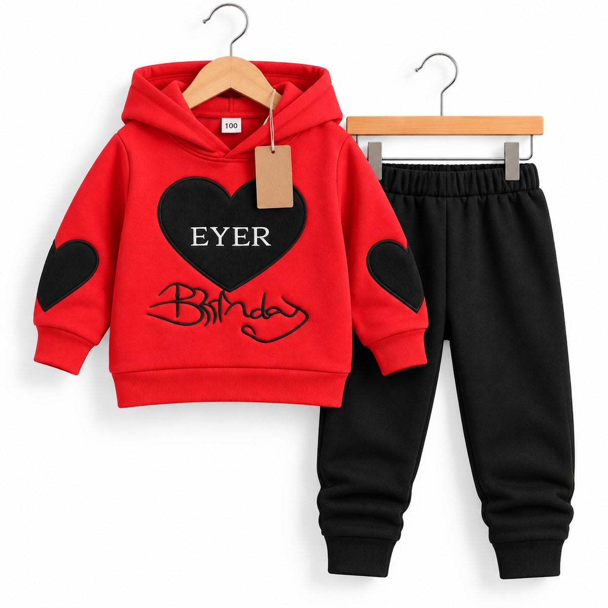 Red hooded sweatshirt with black heart patches and matching black jogger trousers