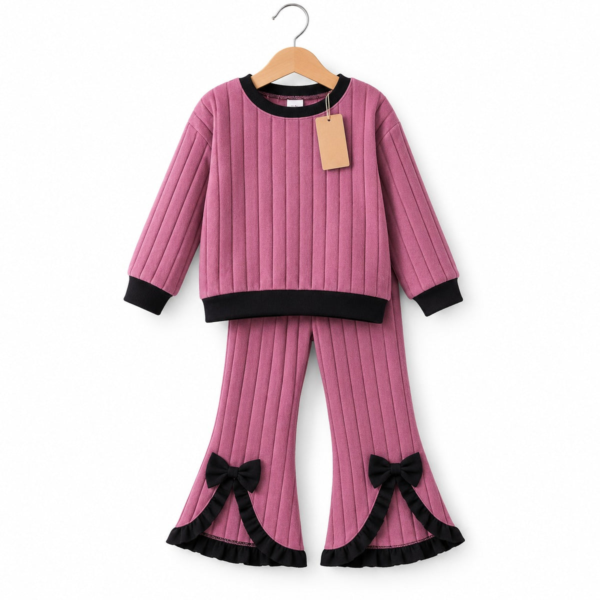 Dusty-pink ribbed long-sleeve top with black trim and matching flared trousers with black bows and ruffled hems
