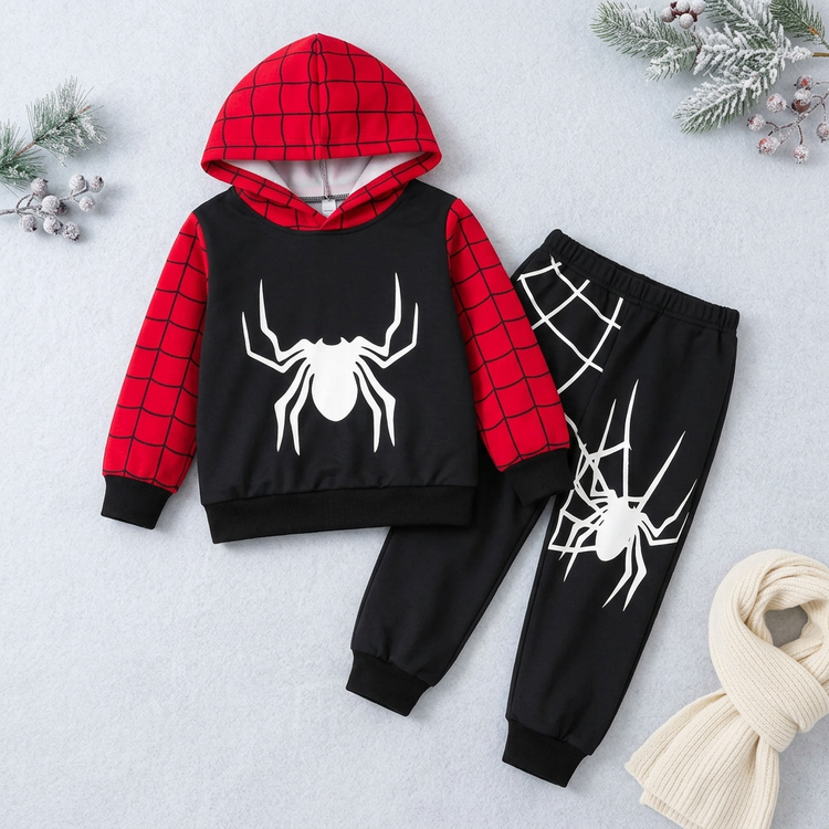 Red-and-black children's spider-print hoodie and matching joggers in a winter catalog setting