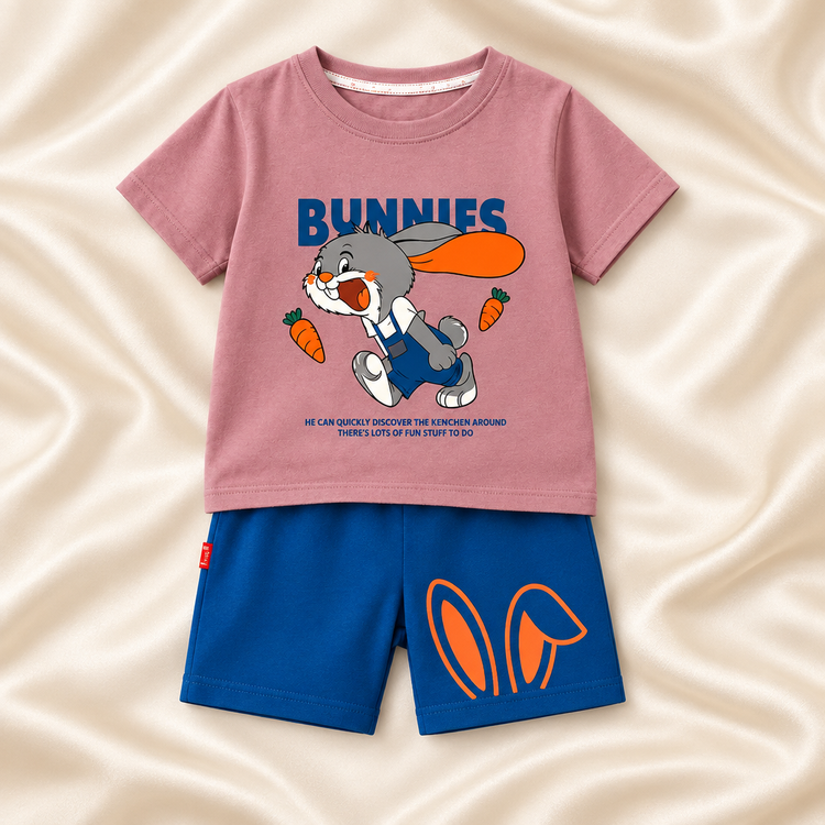 Dusty rose bunny-print kids T-shirt and blue shorts on a silky ivory background
